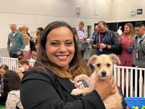 A women and a white puppy.