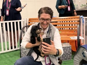 A man and a black puppy.