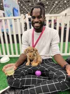 A man in a white shirt with a golden puppy