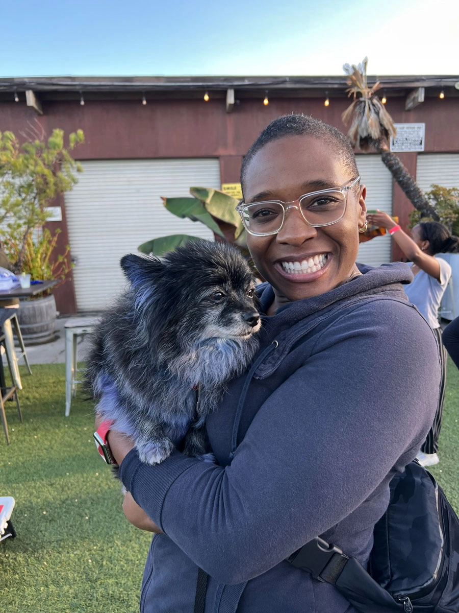A woman enjoying trade show entertainment ideas - especially when they involve puppy love™.