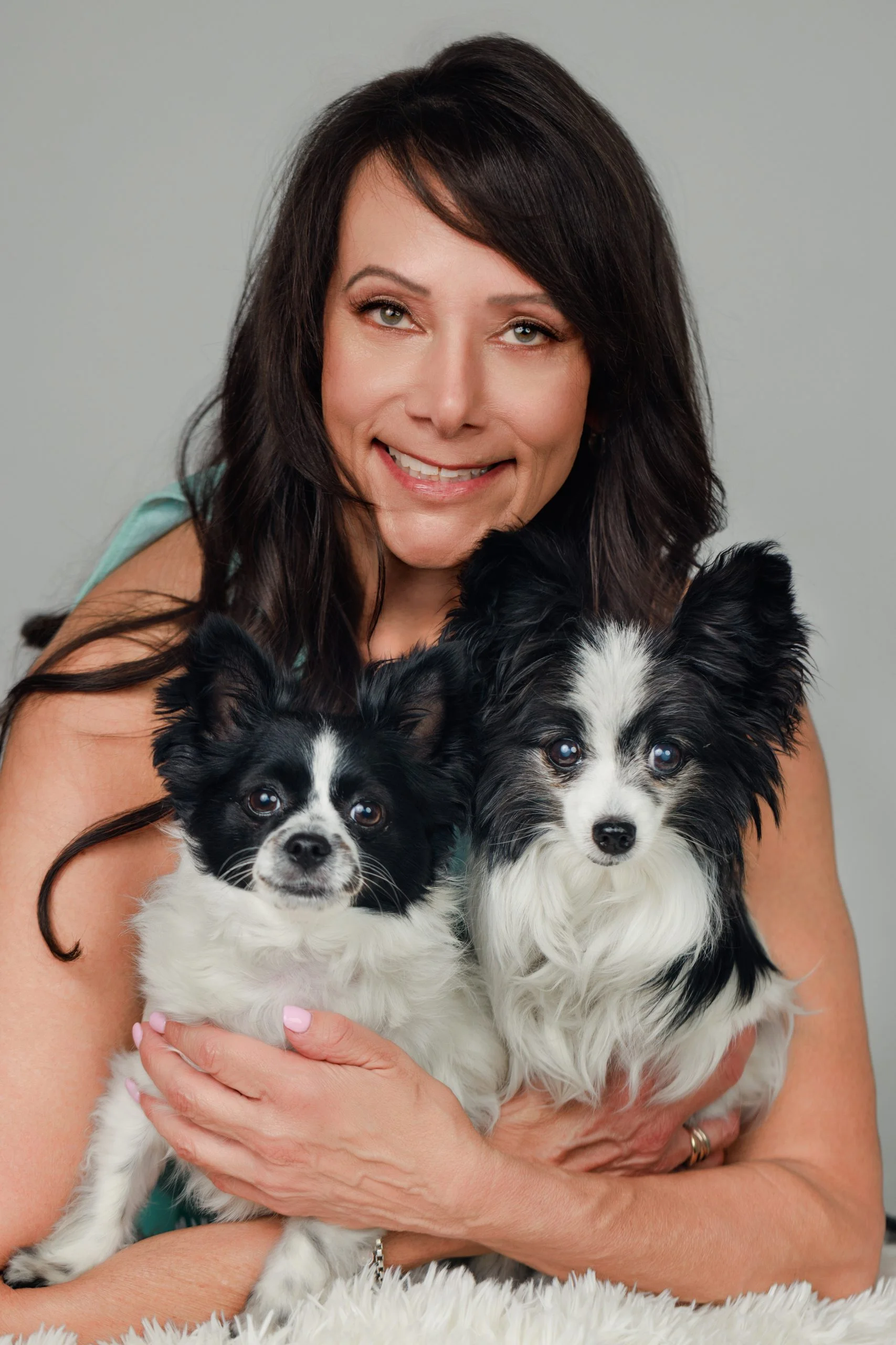 Puppy Love™'s founder Sabrina Freed holding her two dogs.