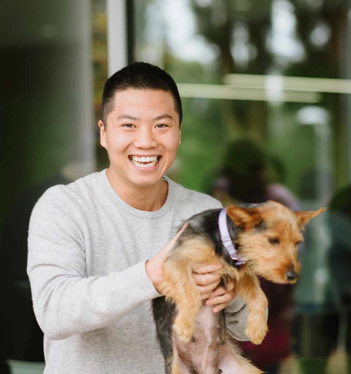 This adorable puppy and employee have fun at a corporate wellness event with puppy love™!.