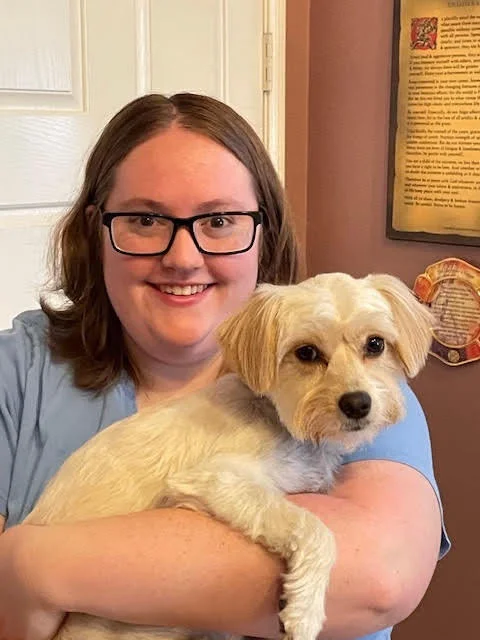 A woman holding a dog