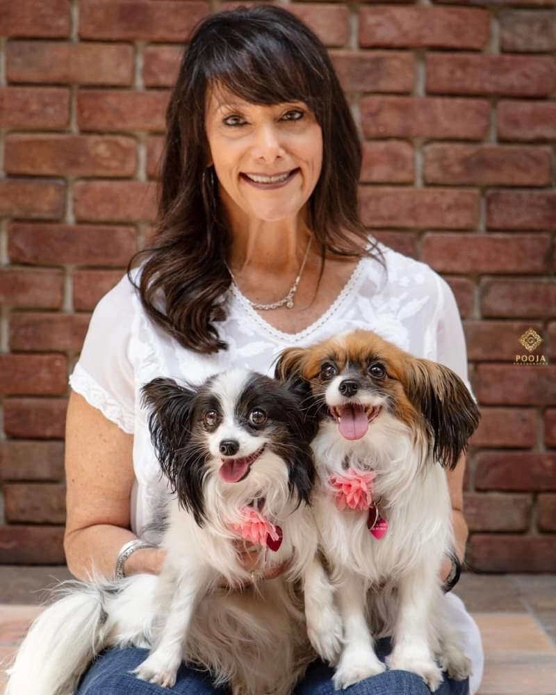 Puppy love™'s founder sabrina freed holding her two dogs.