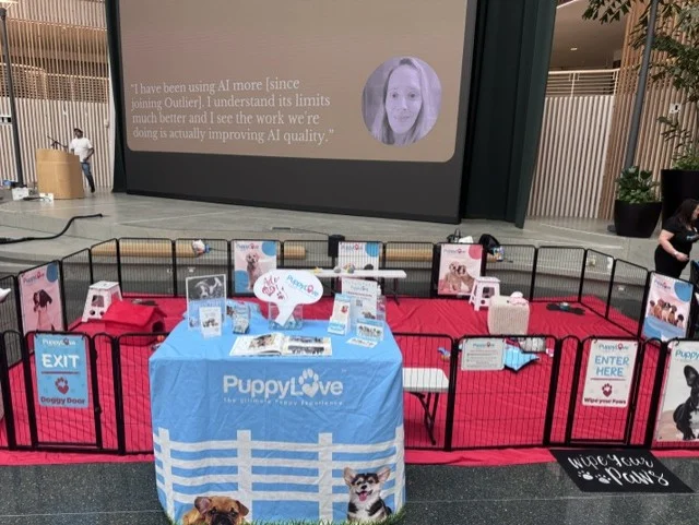 Puppy love puppy play area and welcome booth at a corporate wellness event.